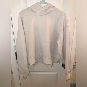 White active wear sweatshirt with thumb holes and textured fabric